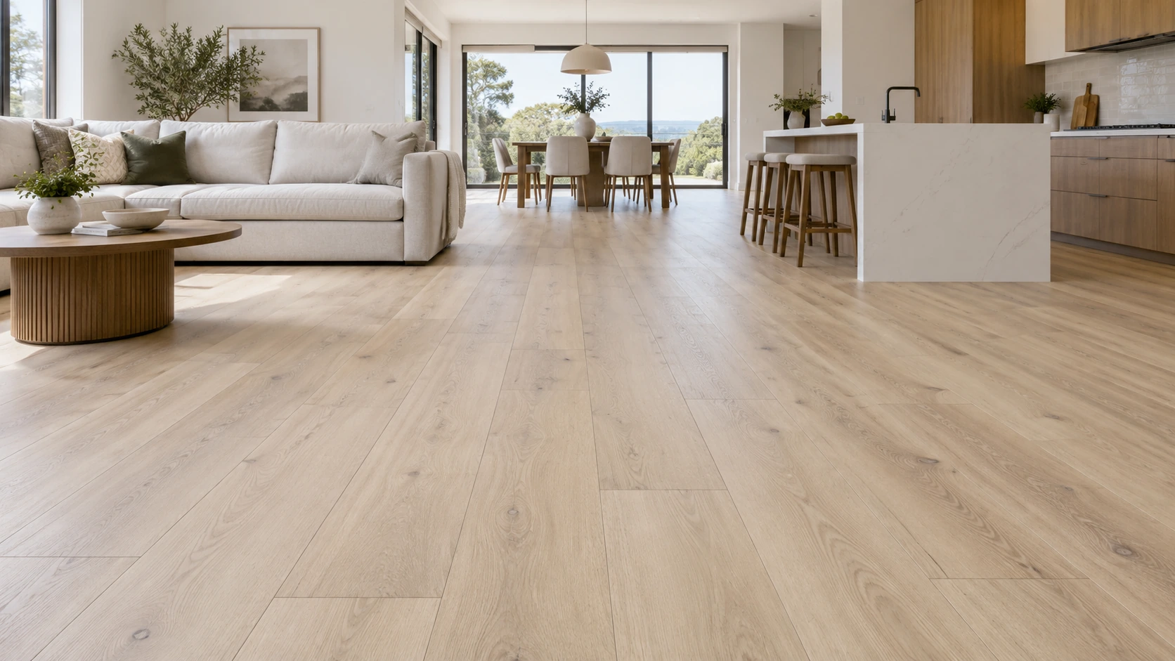 Pale oak-look luxury vinyl plank flooring in a sunlit contemporary living room and kitchen